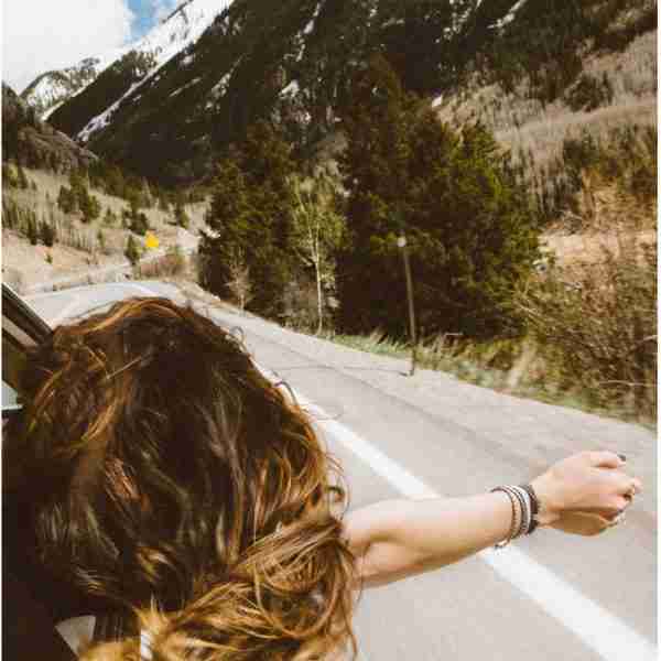 woman riding in a car facing forward