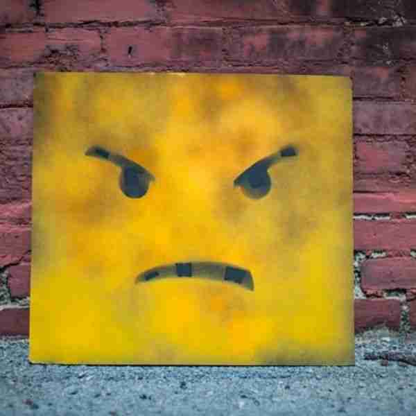 spray painted angry face sign