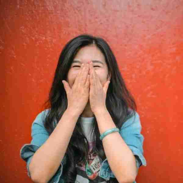woman covering hands with mouths - bonus signs of a good person