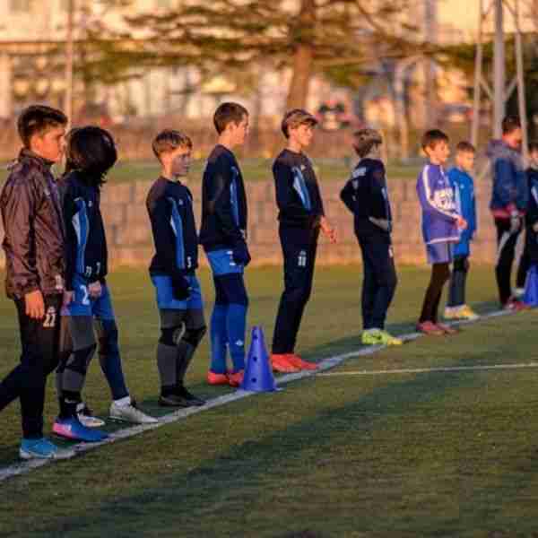 youth soccer players lined up on the field showing good people are on your side