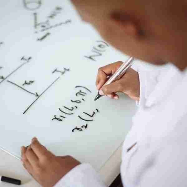 man writing complex formula representing ready for friends test