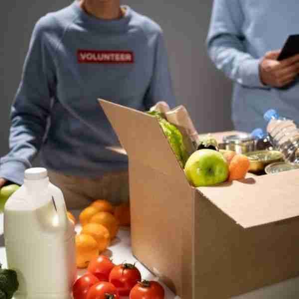 woman and man volunteering at a food pantry - signs of a good person