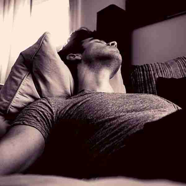 man asleep on sofa representing naps supercharge your brain