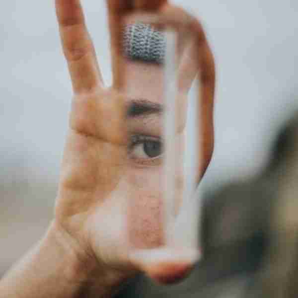 woman looking in a mirror to work on yourself