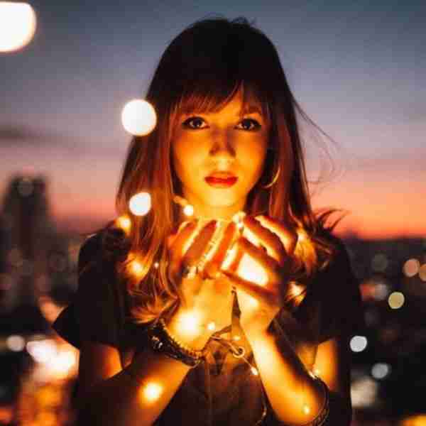 woman holding lights showing how to attract good things to you