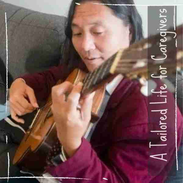 man playing guitar showing music for self-care