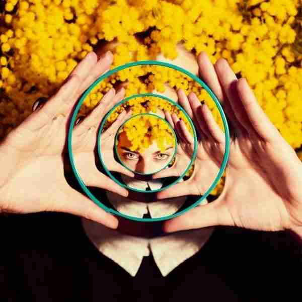 woman in front of a flower background committing to change to be more positive