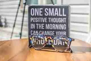 sign with the wording one small positive thought in themorning can change your whole day