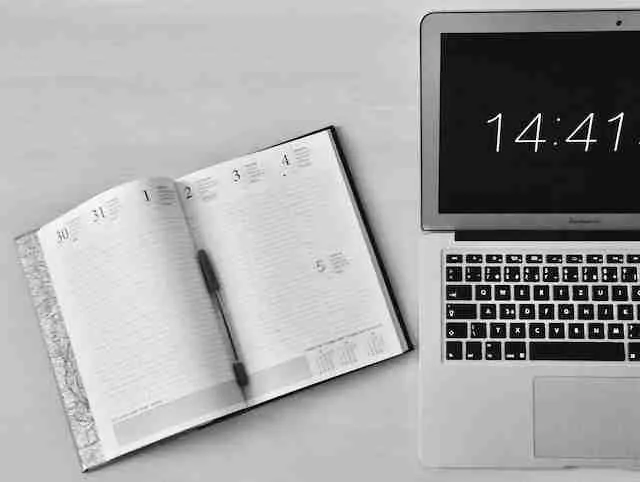 an open calendar and laptop displaying the time 14:41 symboliing Time management Tips for Busy People