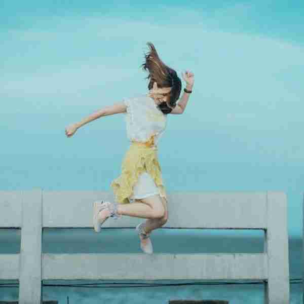 woman jumping for joy in air